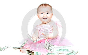 Infant baby girl playing with money