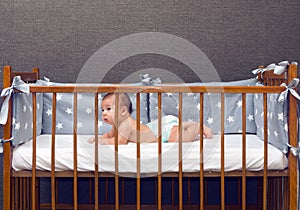 Infant baby laying in decorated cot