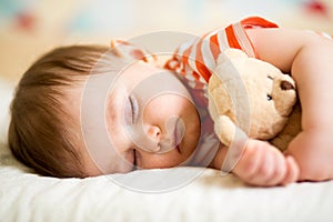 Infant baby sleeping with plush toy