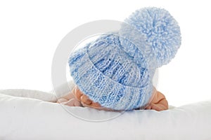 Infant with blue knit hat