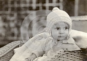 Infant boy in 1923 dressed in warm knit sweater and hat.