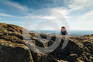 Infant boy climbing a mountain