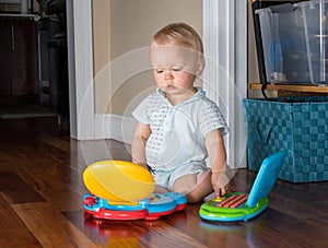 Infant caucasian boy working on two computers at the same time