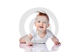 Infant child baby boy kid with blue eyes happy smiling screaming lying on a floor isolated on a white background