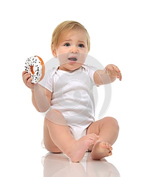 Infant child baby boy toddler playing on a floor on and looking