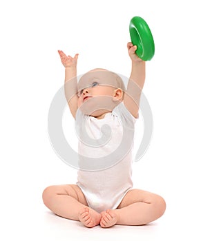 Infant child baby boy toddler playing holding green circle in ha