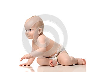 Infant child baby girl crawling and happy looking at the corner photo