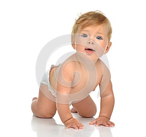 Infant child baby girl in diaper crawling happy looking at the c