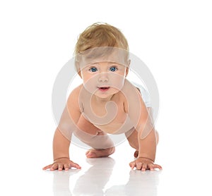 Infant child baby girl in diaper crawling happy looking at the c