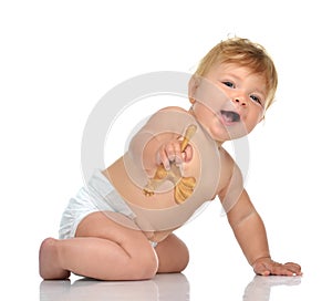 Infant child baby girl in diaper crawling happy looking at the c