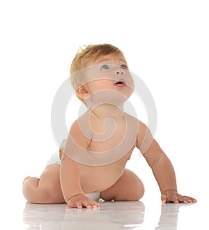 Infant child baby girl in diaper crawling happy looking up