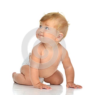 Infant child baby girl in diaper crawling happy looking up