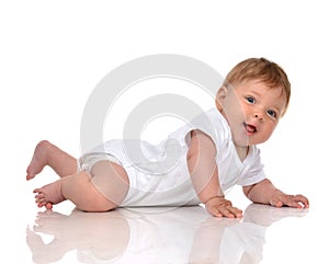 Infant child baby girl in diaper lying happy smiling looking at