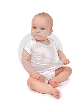 Infant child baby girl in diaper sitting and happy looking at th