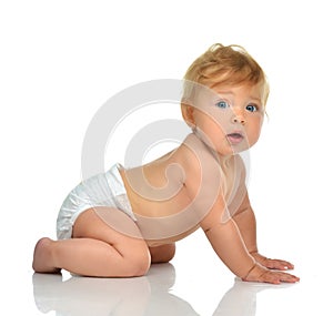 Infant child baby girl kid in diaper crawling happy looking at t