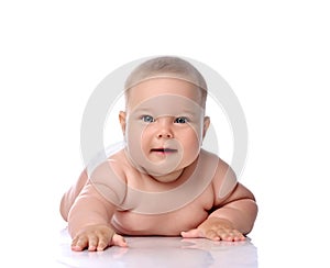 Infant child baby girl kid in diaper lying happy looking at the camera isolated on a white