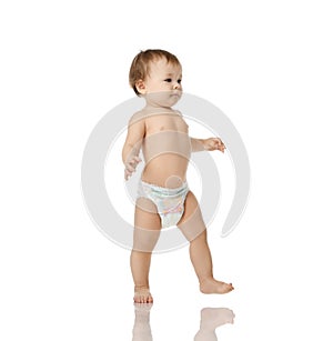 Infant child baby girl kid toddler in diaper make first steps