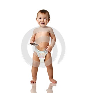 Infant child baby girl kid toddler in diaper make first steps with mobile cellphone isolated on a white