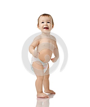 Infant child baby girl kid toddler in diaper make first steps standing happy smiling laughing isolated on a white