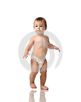 Infant child baby girl kid toddler in diaper make first steps photo