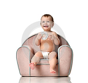 Infant child baby girl kid toddler in diaper sit in little armchair chair