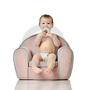 Infant child baby girl kid toddler in diaper sit in little armchair chair photo