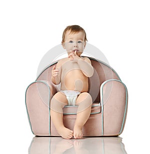 Infant child baby girl kid toddler in diaper sit in little armchair chair photo