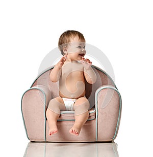 Infant child baby girl kid toddler in diaper sit in little armchair chair