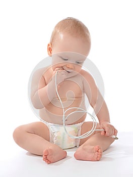 Infant child baby girl sitting and hold in hands power charger c