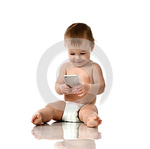 Infant child baby girl toddler playing with mobile cellphone happy smiling