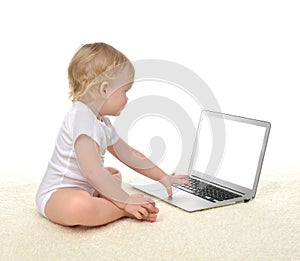 Infant child baby girl toddler sitting with computer laptop keyboard