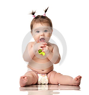Infant child baby girl toddler sitting in diaper happy smiling laughing playing with plastic toy ice cream isolated