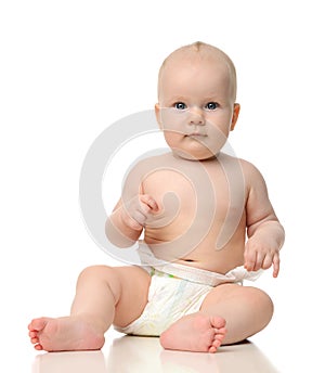 Infant child baby girl toddler sitting in diaper looking a