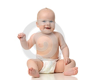 Infant child baby girl toddler sitting in diaper looking a