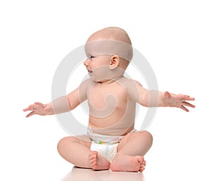 Infant child baby girl toddler sitting in diaper looking a