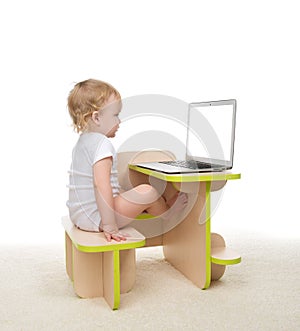 Infant child baby girl toddler sitting with hands typing on mode