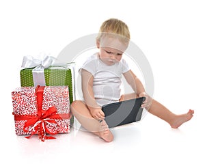 Infant child baby toddler kid with tablet pc device ordering presents gifts