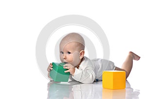 Infant child baby toddler sitting in diaper with green red educational brick toy playing