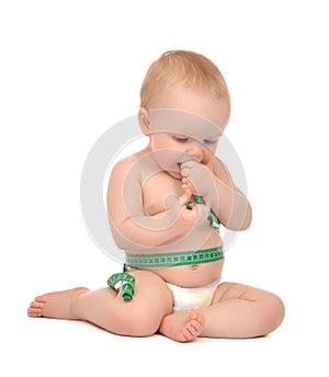 Infant child baby toddler sitting playing with tape measure meas