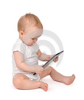 Infant child baby toddler sitting and typing digital tablet mobile