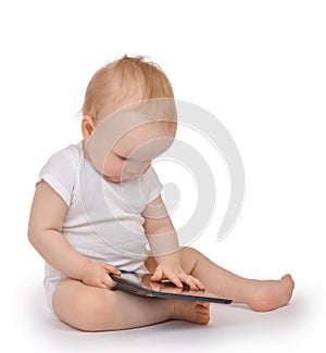 Infant child baby toddler sitting and typing digital tablet mobile computer