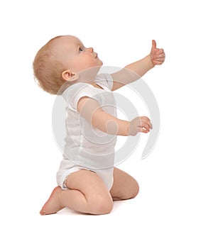 Infant child baby toddler smiling with hand thumb up sign