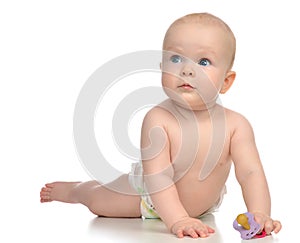 Infant child girl lying happy holding baby nipple soother