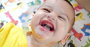 infant, childhood concept - close-up of smiling happy Baby plays with a teether. Teeth cutting. First teeth. Joy