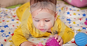 infant, childhood concept - close-up of smiling happy Baby plays with a teether. Teeth cutting. First teeth. Joy