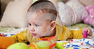 infant, childhood concept - close-up of smiling happy Baby plays with a teether. Teeth cutting. First teeth. Joy