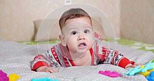 infant, childhood concept - close-up of smiling happy Baby plays with a teether. Teeth cutting. First teeth. Joy