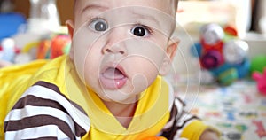 infant, childhood concept - close-up of smiling happy Baby plays with a teether. Teeth cutting. First teeth. Joy