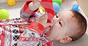 infant, childhood concept - close-up of smiling happy Baby plays with a teether. Teeth cutting. First teeth. Joy