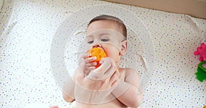 infant, childhood concept - close-up of smiling happy Baby plays with a teether. Teeth cutting. First teeth. Joy